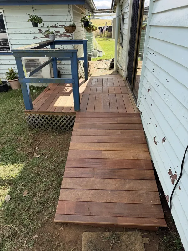New hardwood walkway beside the same house, after