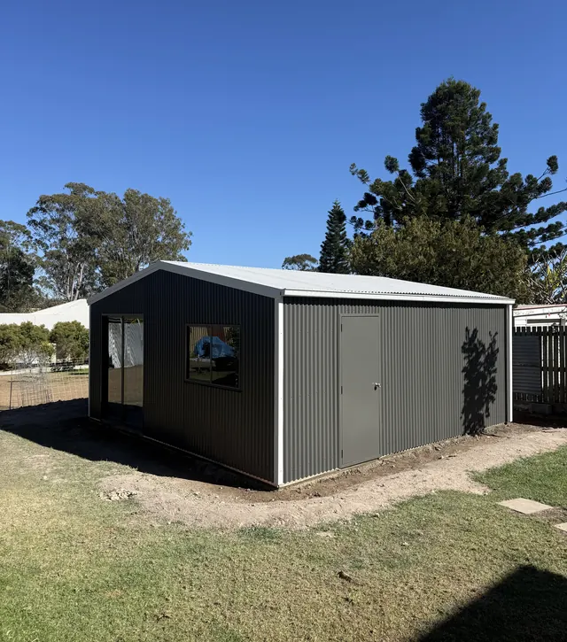 Steel shed with windows and an access door
