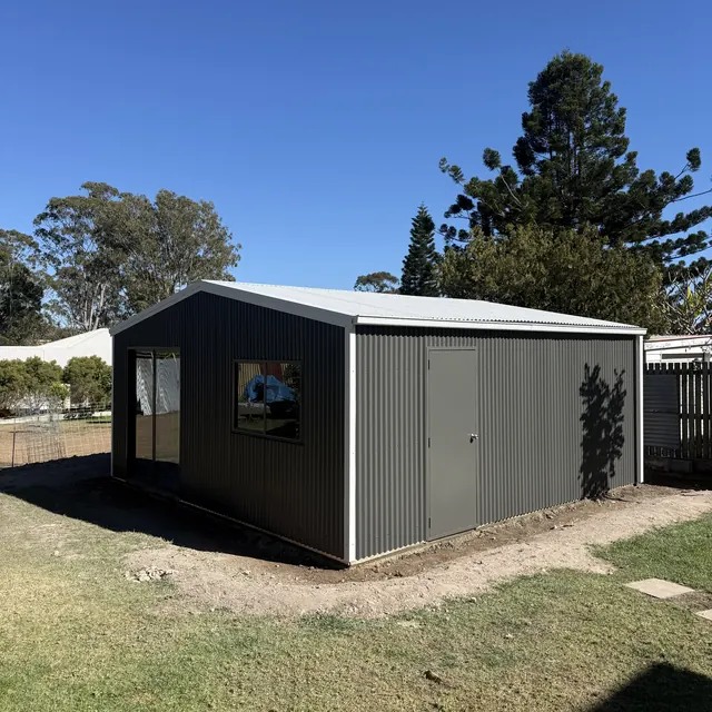 Finished steel shed with windows and an access door